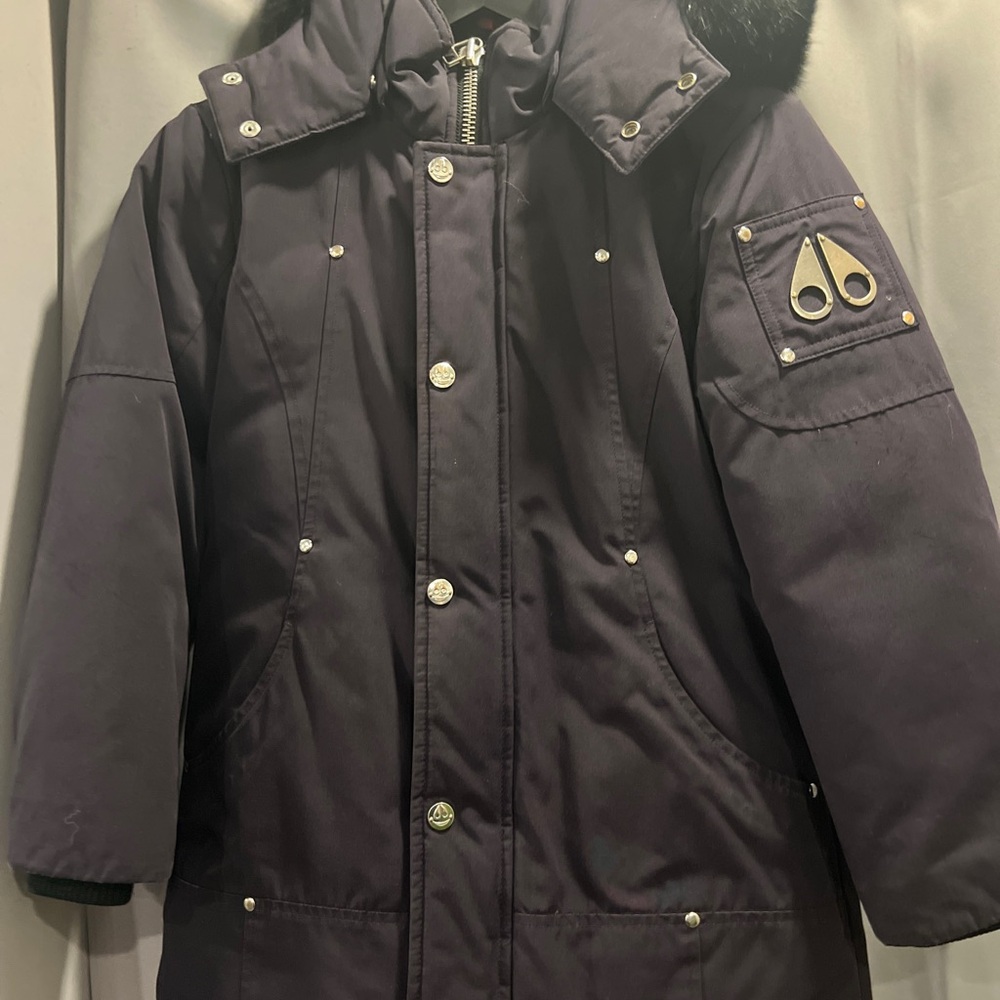 Navy blue Moose Knuckle winter jacket with black fur. Size kids small unisex.